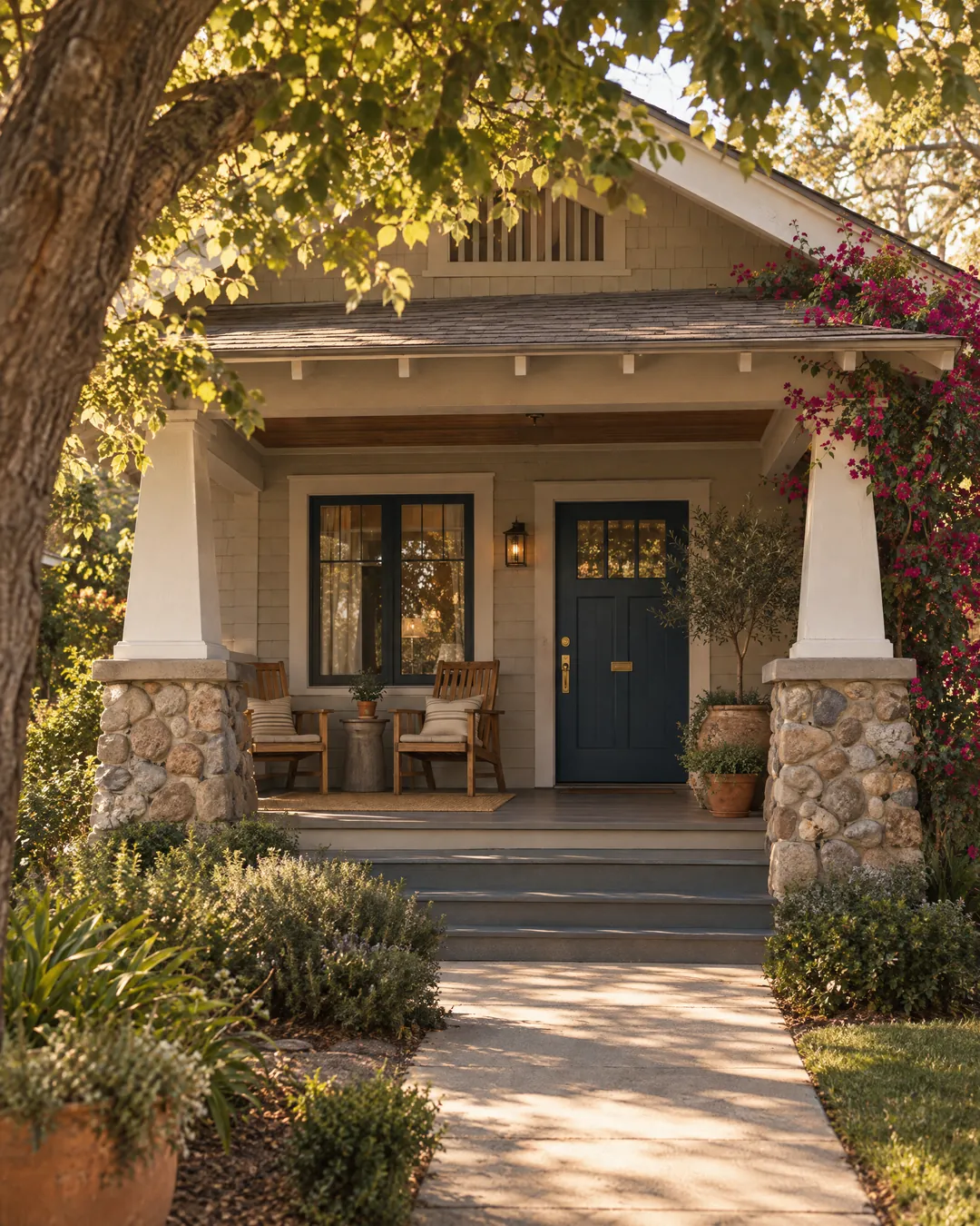 A restored craftsman bungalow porch with a navy front door